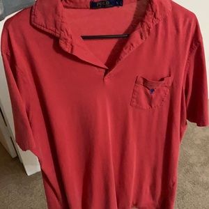 Red polo collared shirt with blue horse in it.